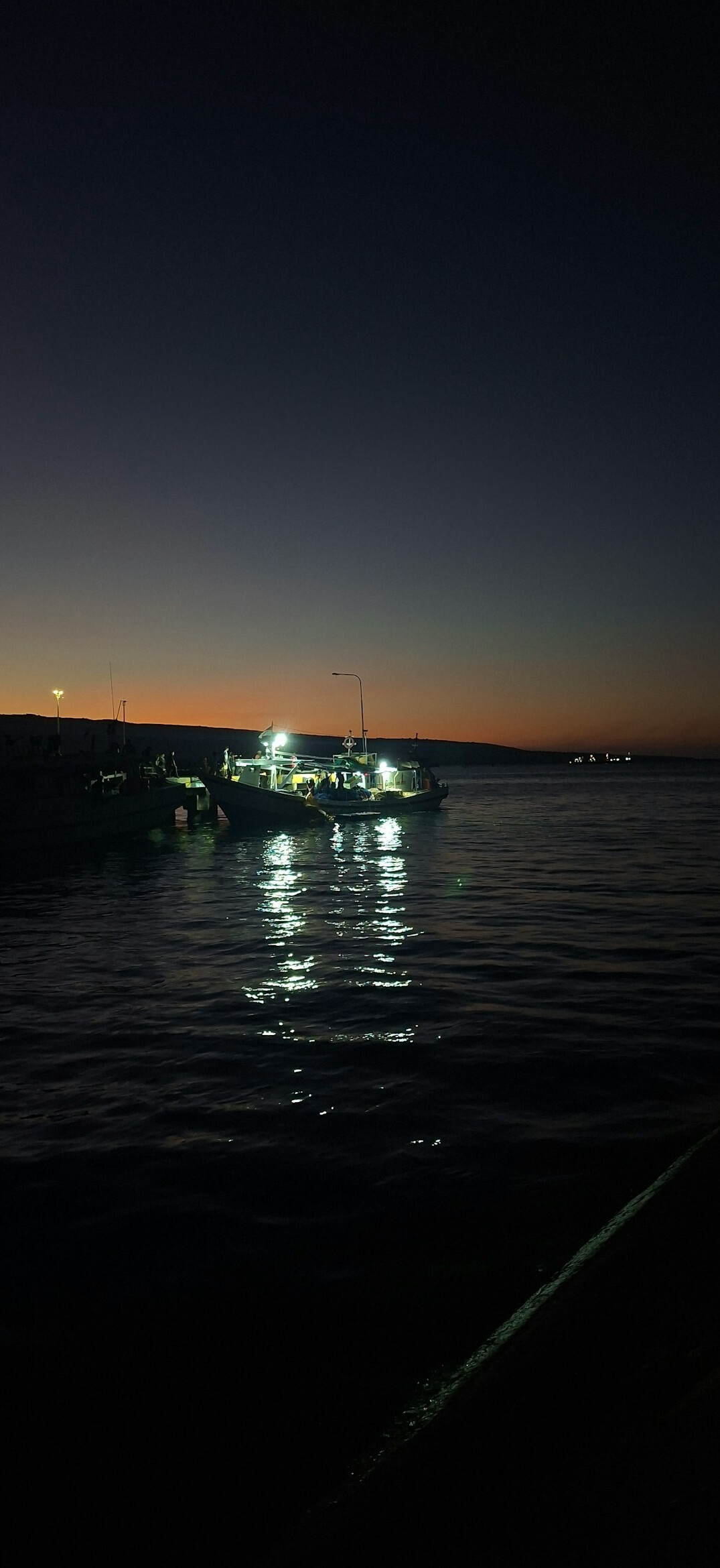 Danish fishing harbor at dawn with boats and fog