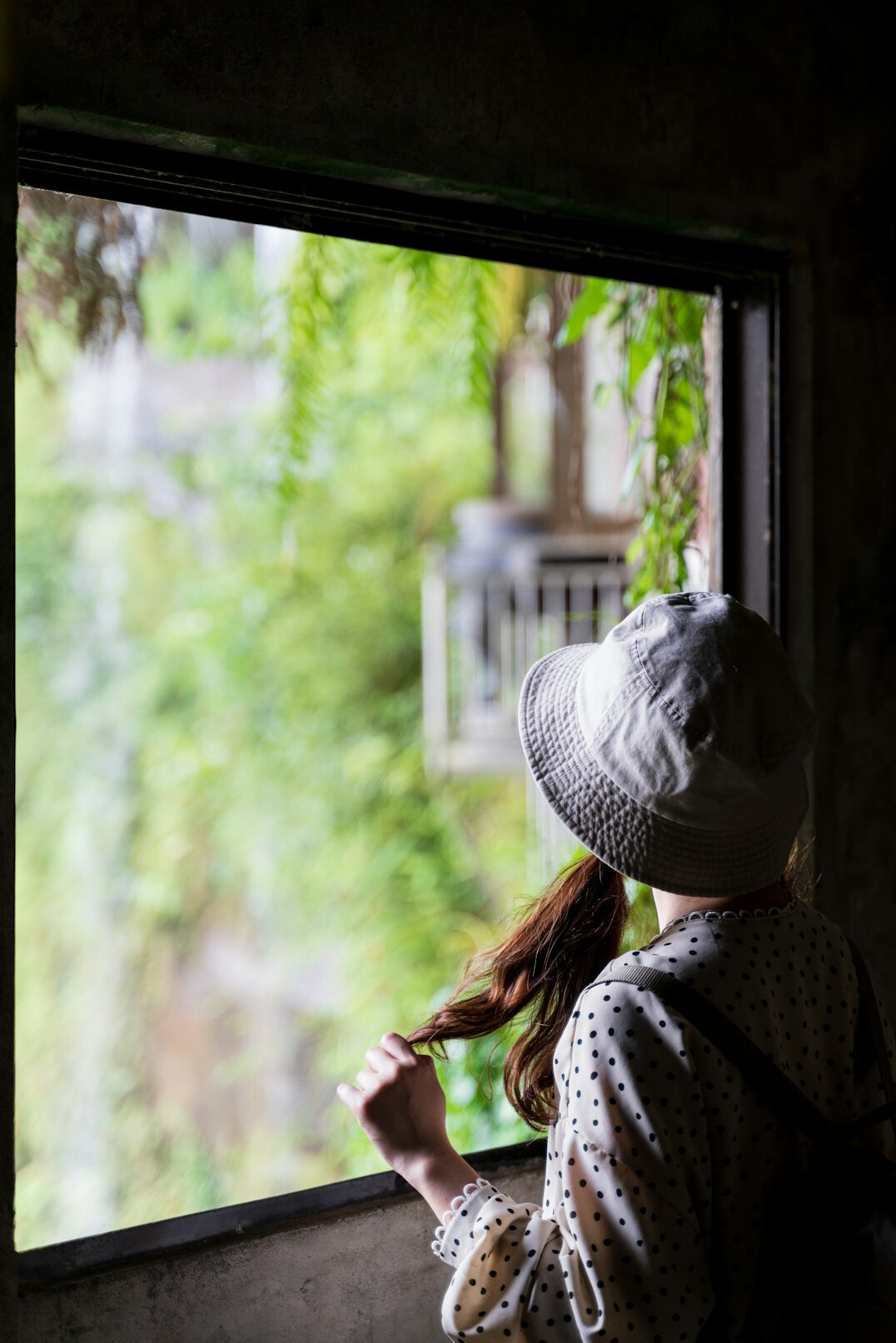 Elderly Danish woman knitting wool by a window